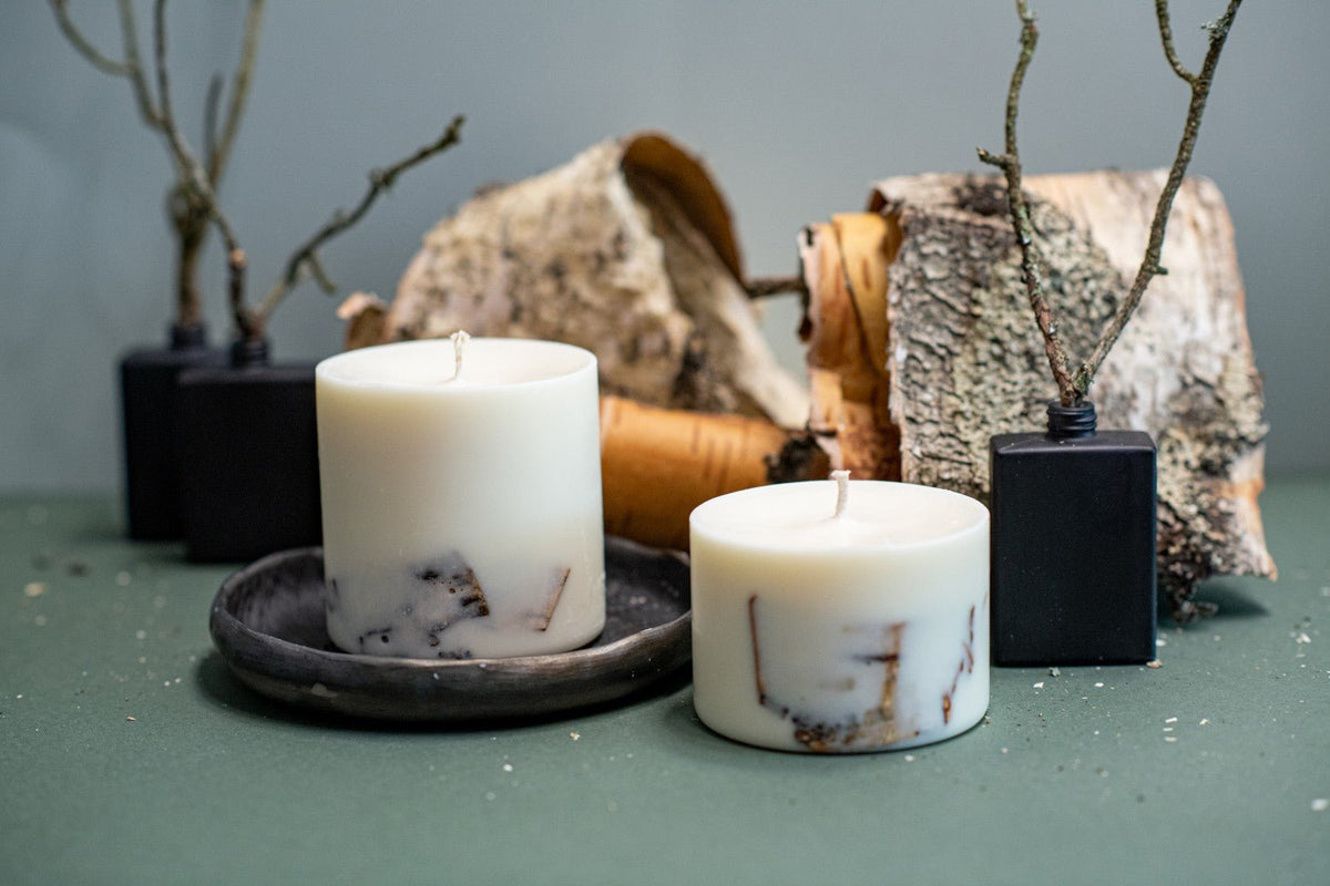 Handmade pillar candles with natural decorative elements