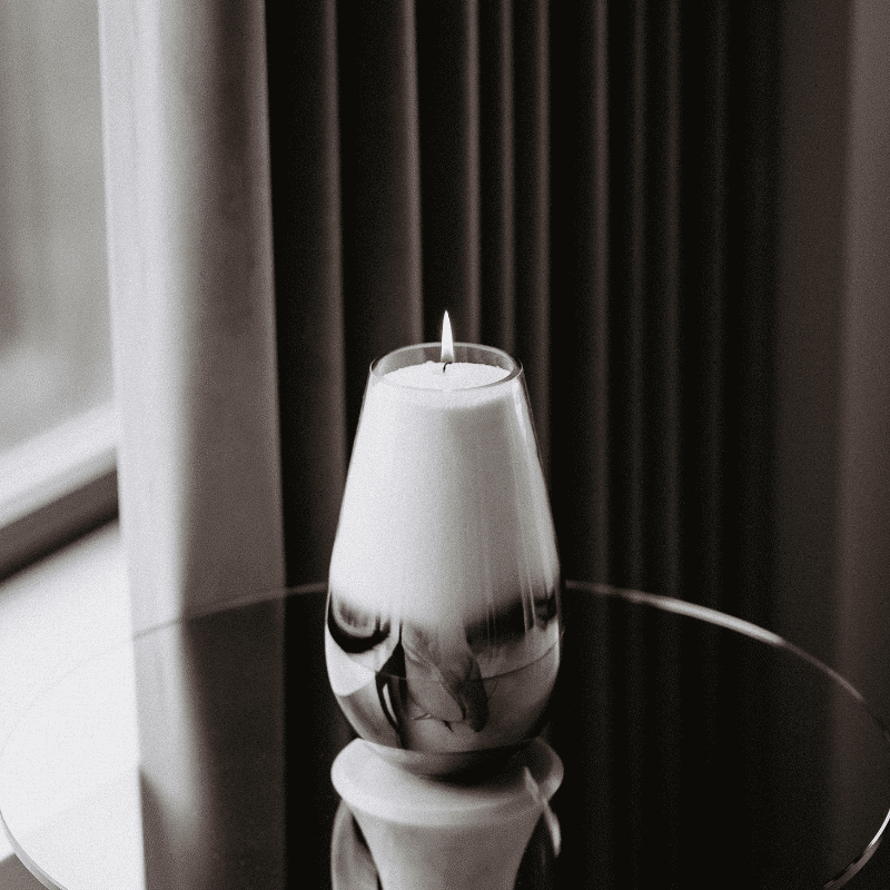 Bougie en poudre non parfumée dans un récipient en verre sur une table d’appoint