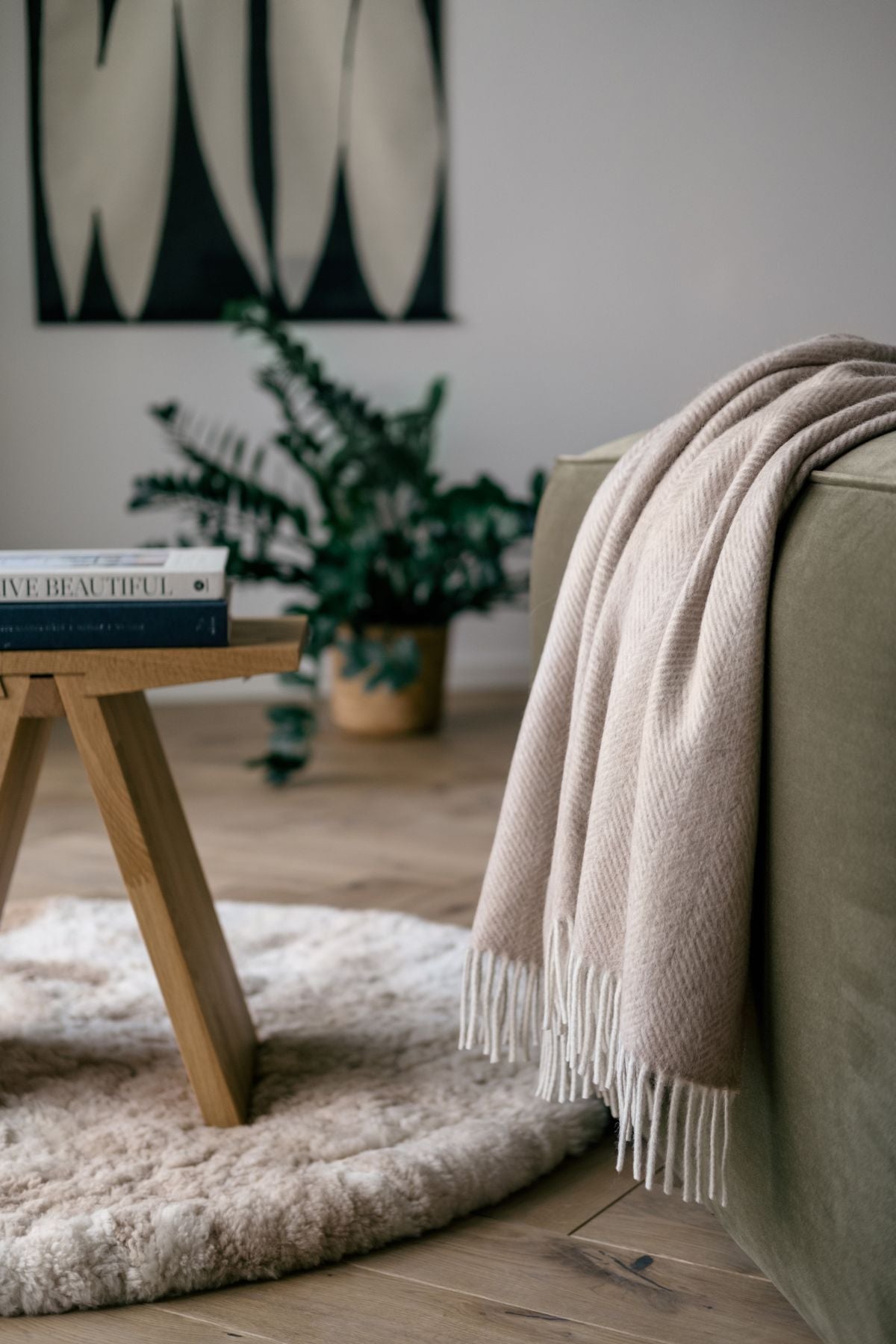 Alpaca wool throws in silver grey draped over a sofa