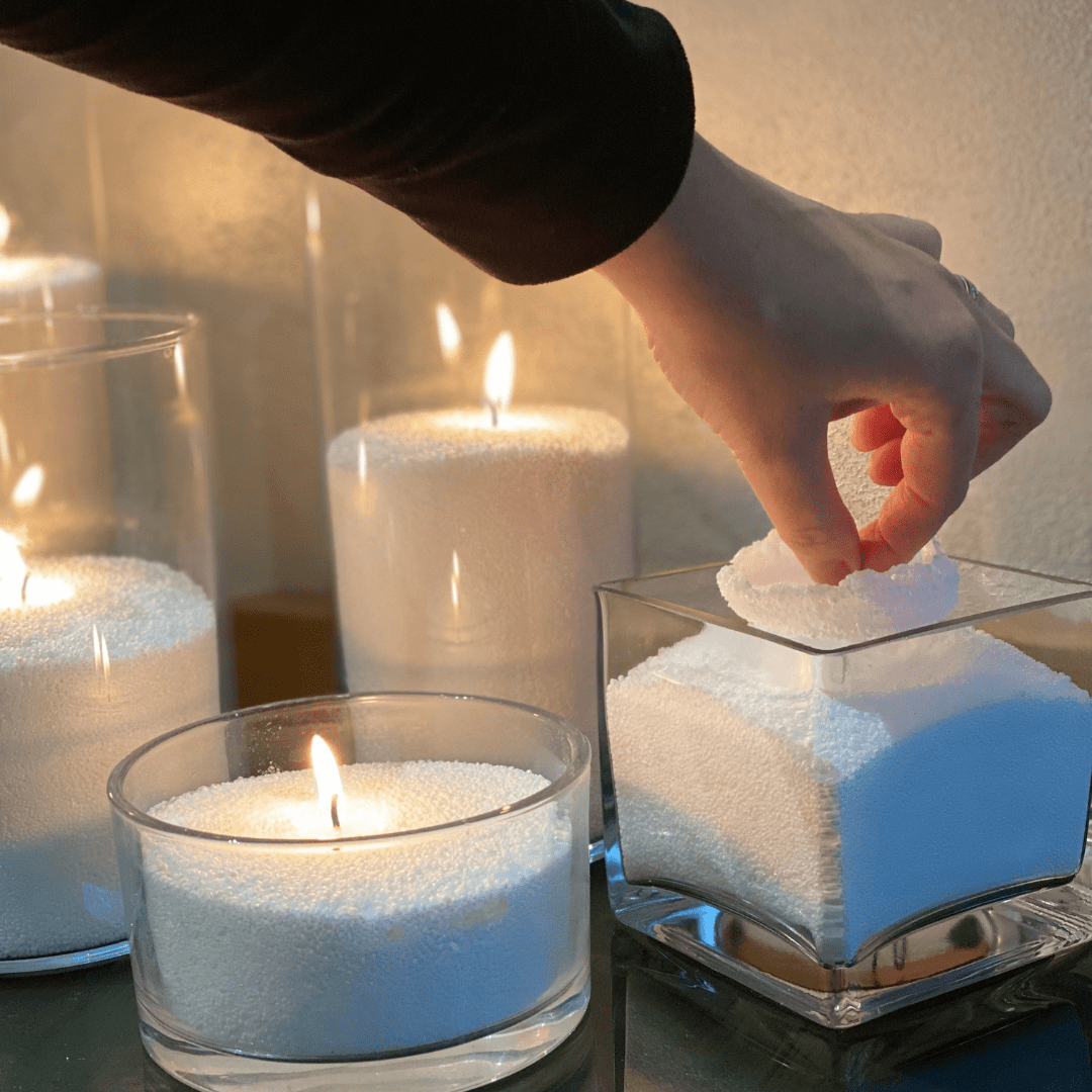 Adding a wick to a powdered candle in a glass container