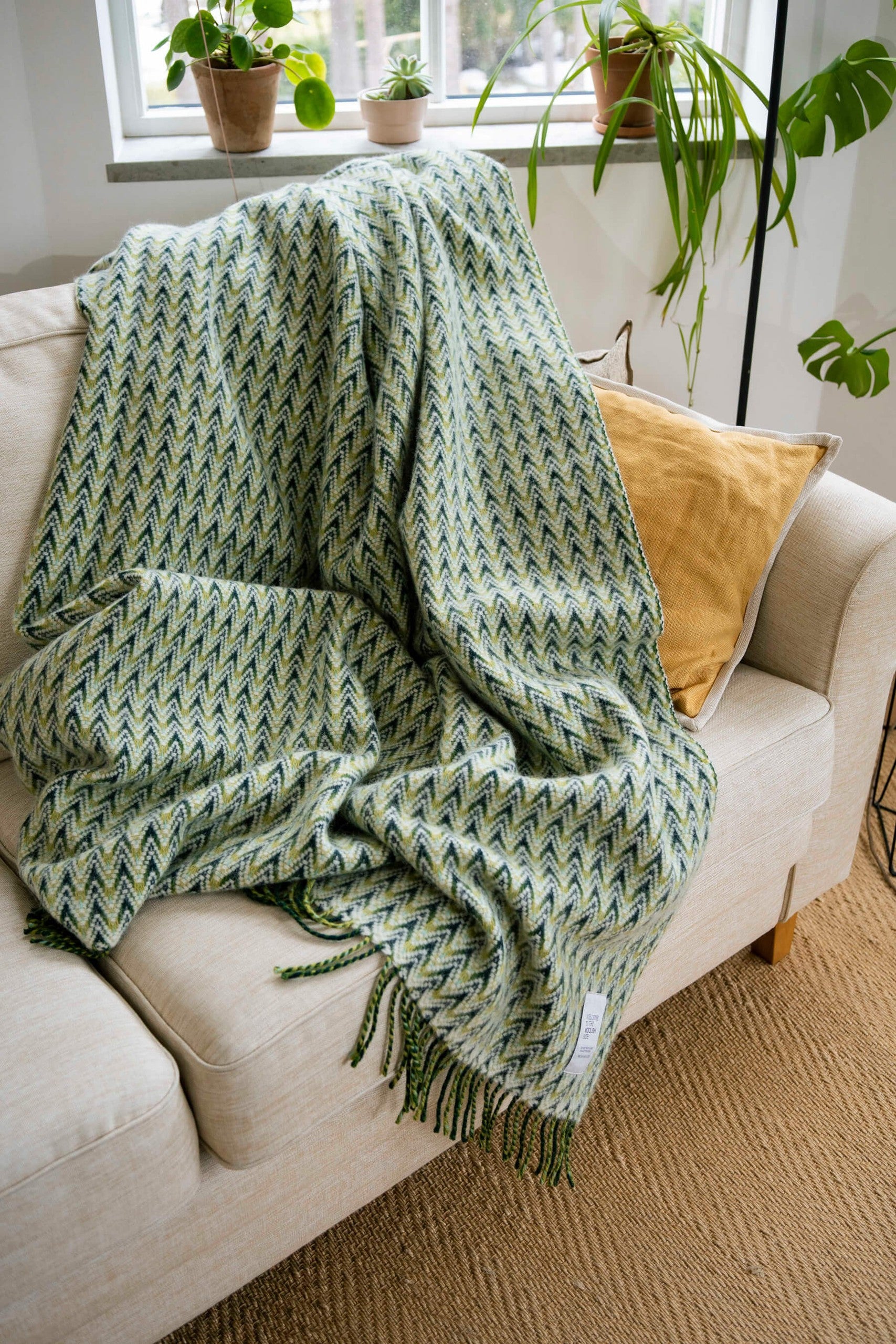 Amai wool throw styled on a sofa