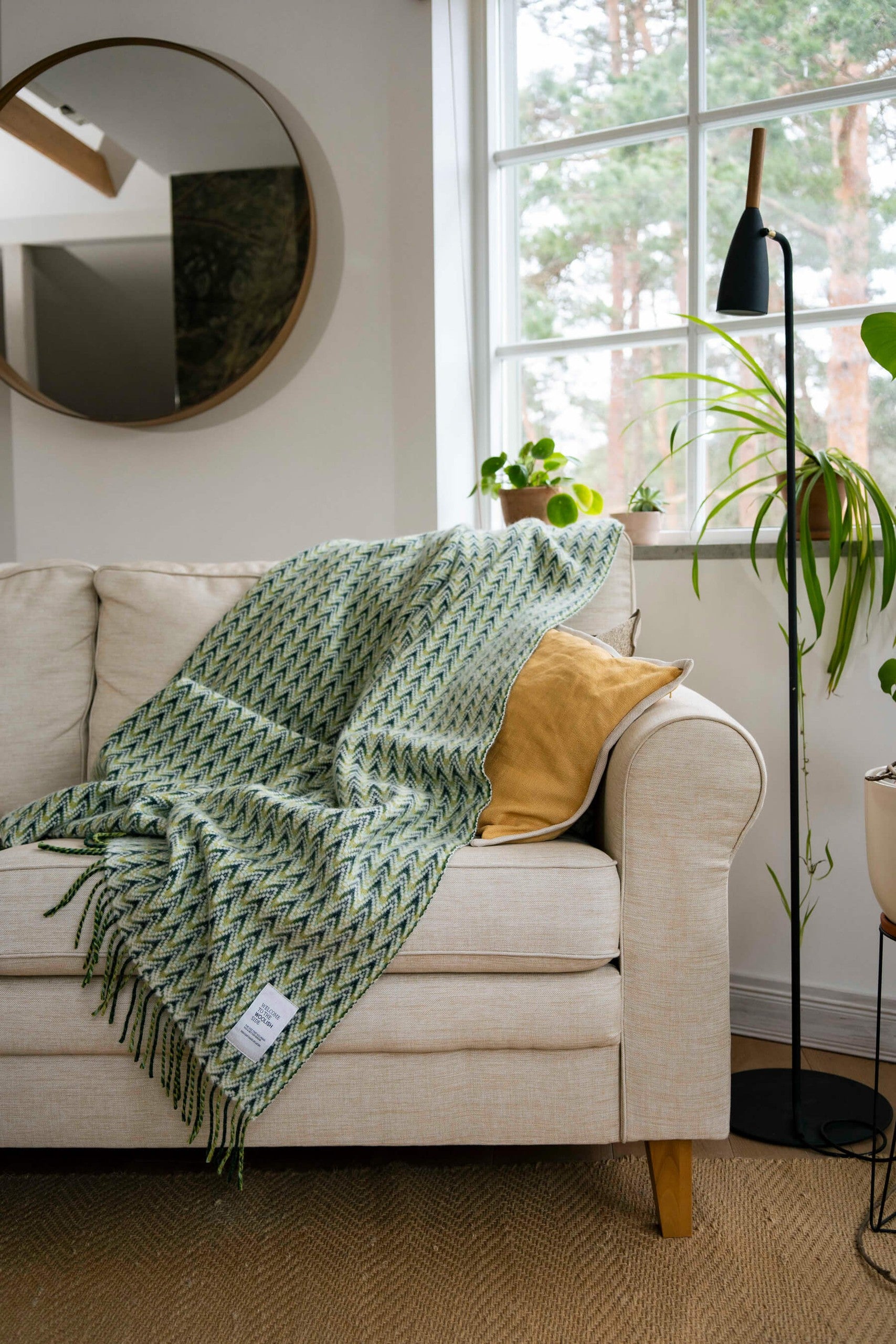 Amai wool throw styled on a sofa