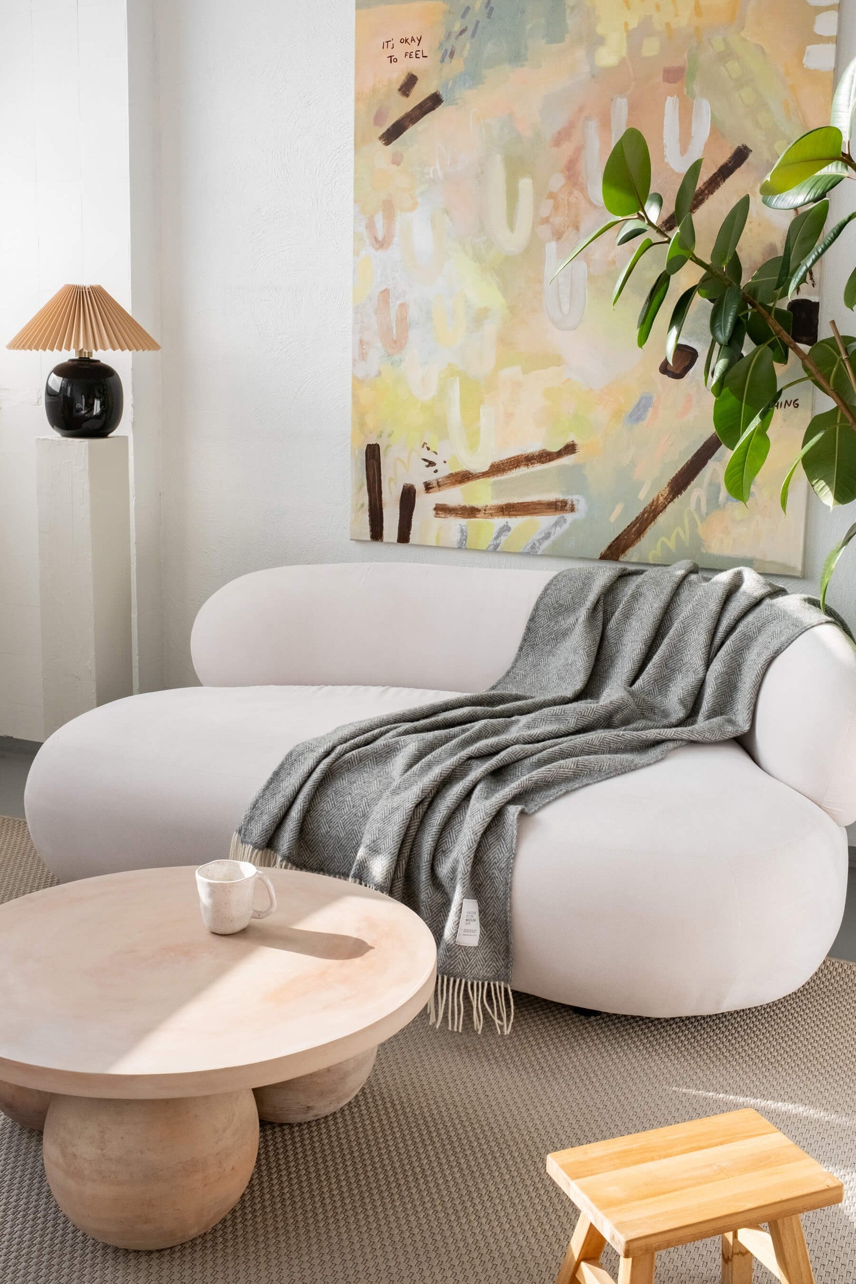 Hera pure wool throw blanket 130 x 170 cm on a white sofa