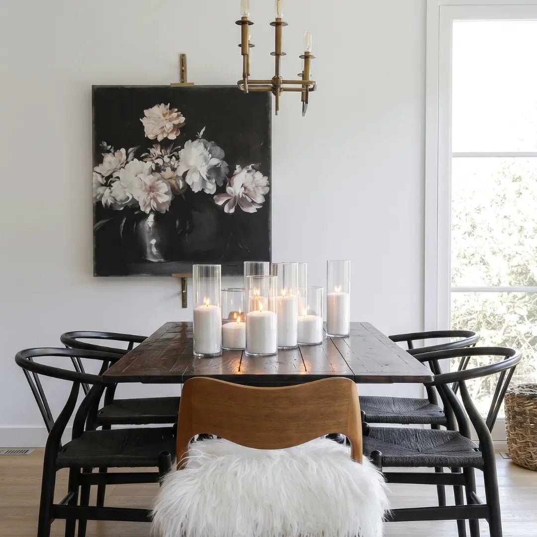 White candle sand candles displayed on a dark dining table