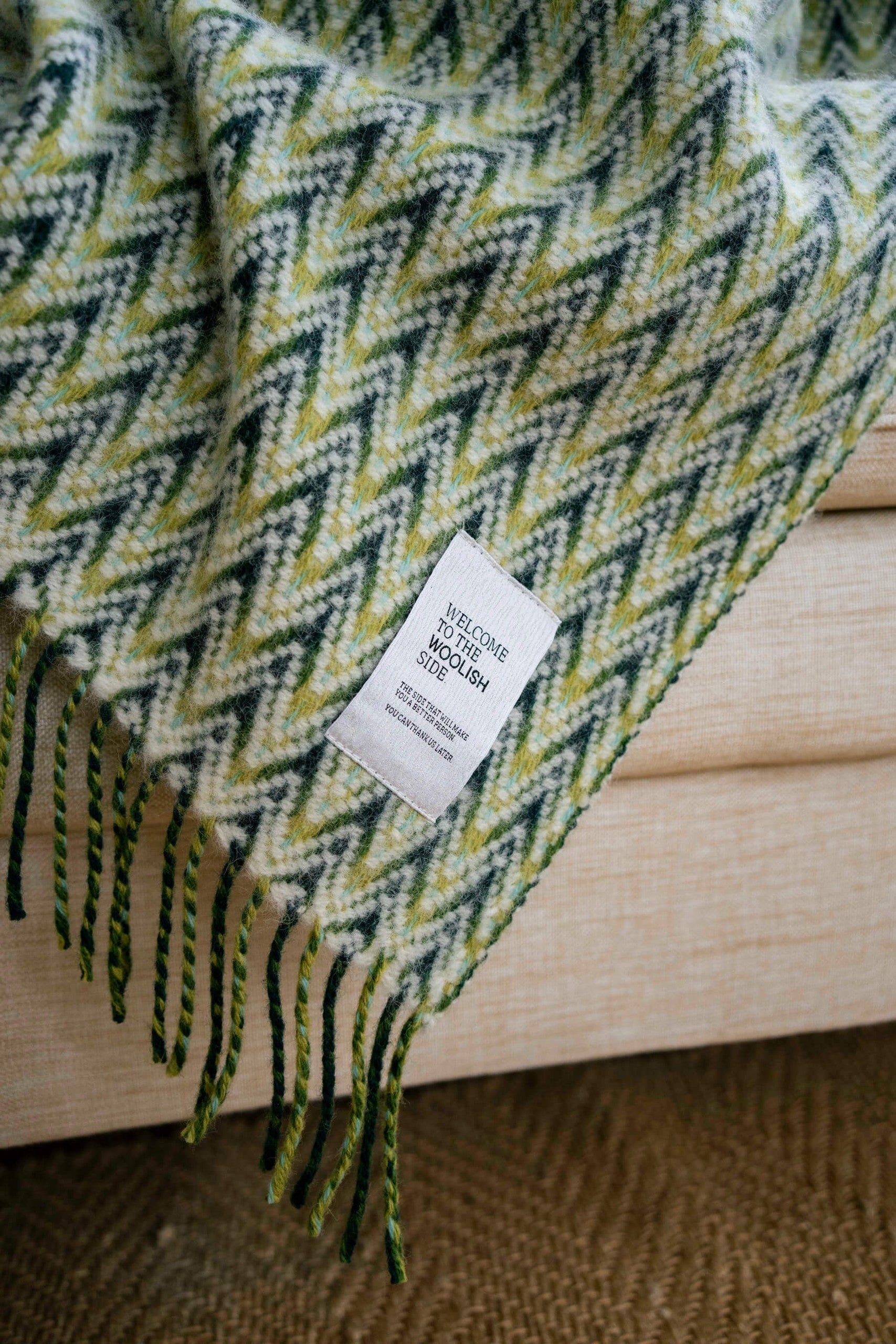 Amai wool throw styled on a sofa