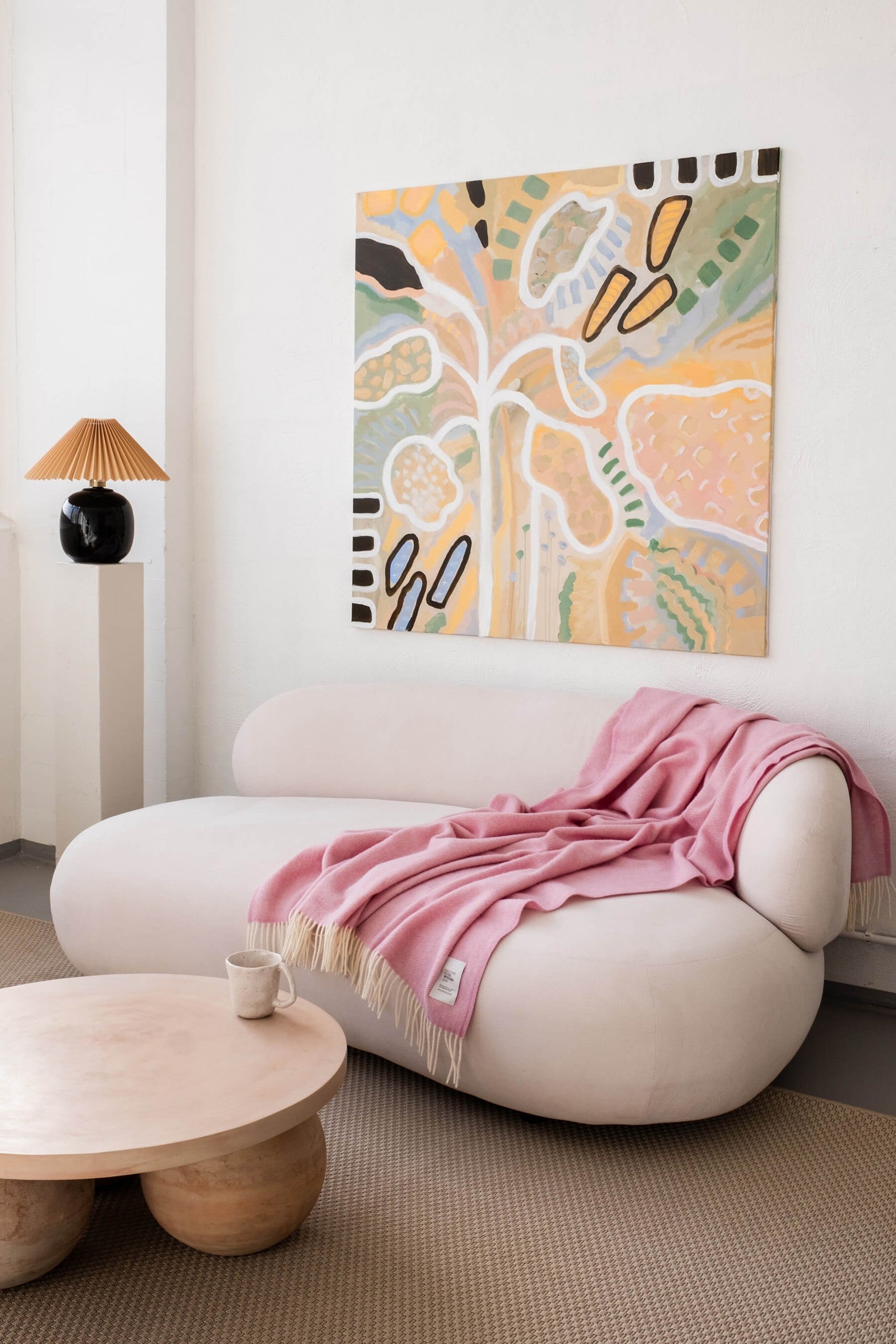Mira wool throw in gift box styled on a sofa