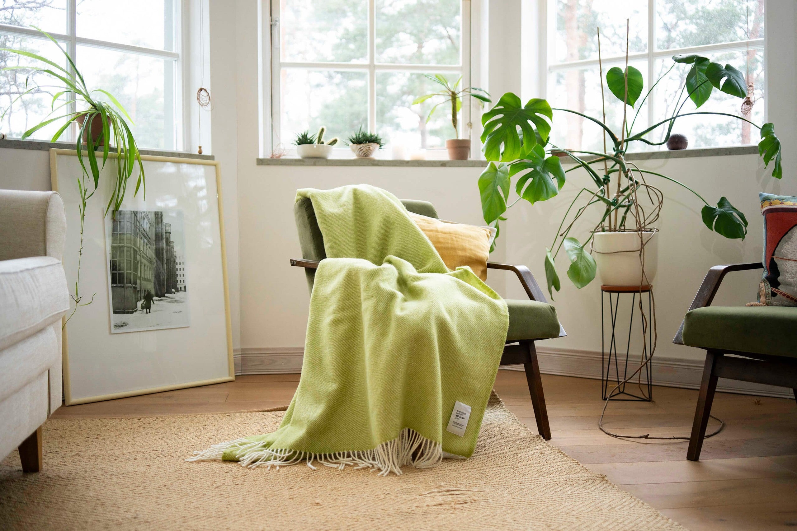 Mira wool throw in gift box draped over a lounge chair